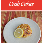 Pin Image: Text, a plate with a crab cake on it and a lemon slice.