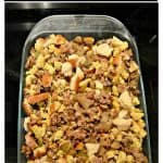 Pin Image: Text overlay, A baking dish filled with cornbread and white bread stuffing with bits of sausage, celery, and mushrooms mixed in.
