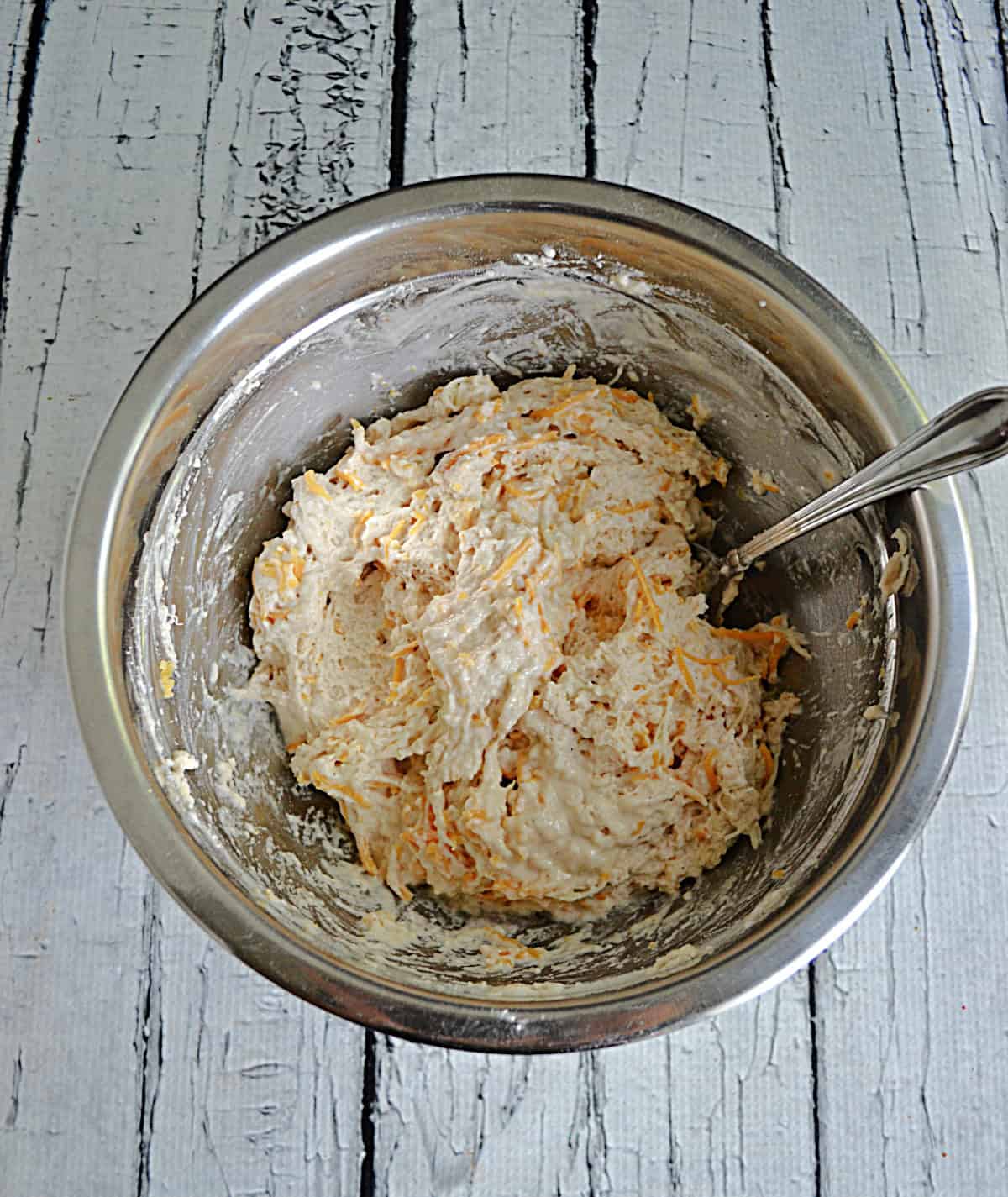 A bowl of cheddar beer bread dough.