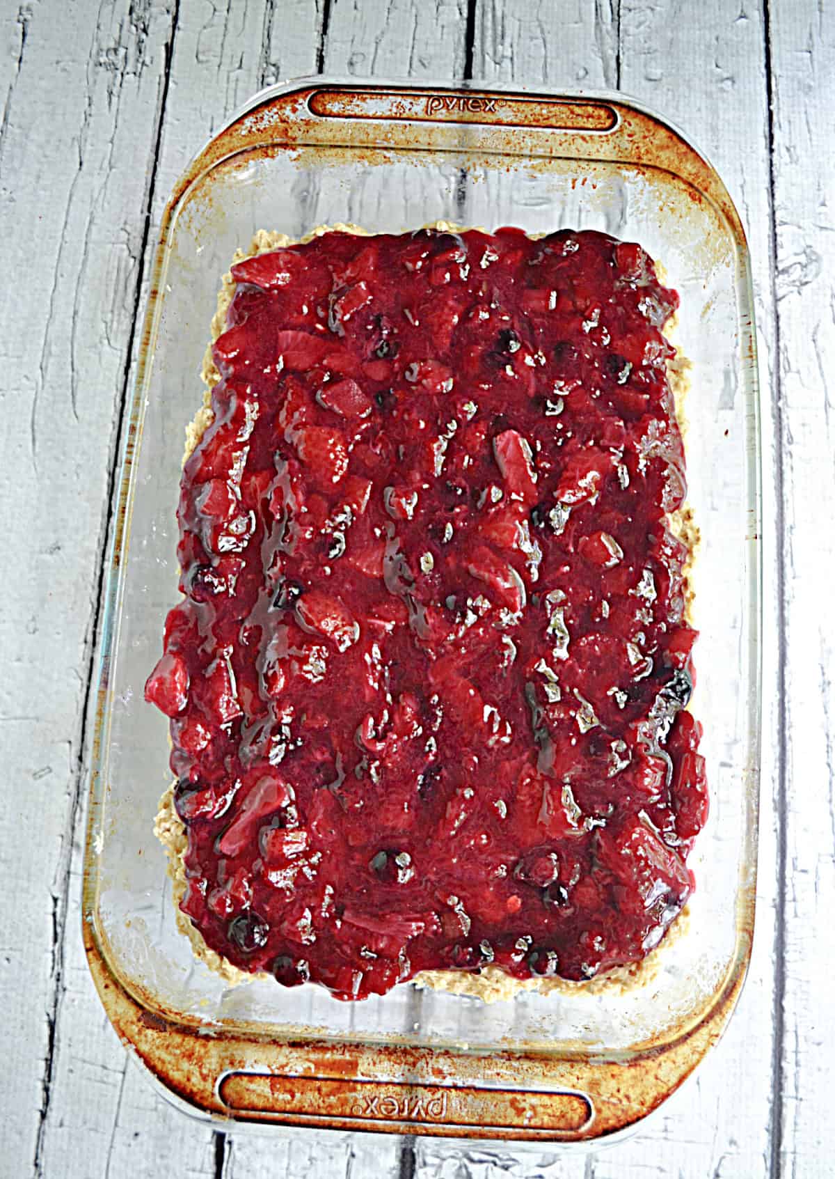 A pan of cookie bars with berry rhubarb jam on top.