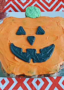 A large pull apart Pumpkin Cupcakes with black jack-o-lantern face.