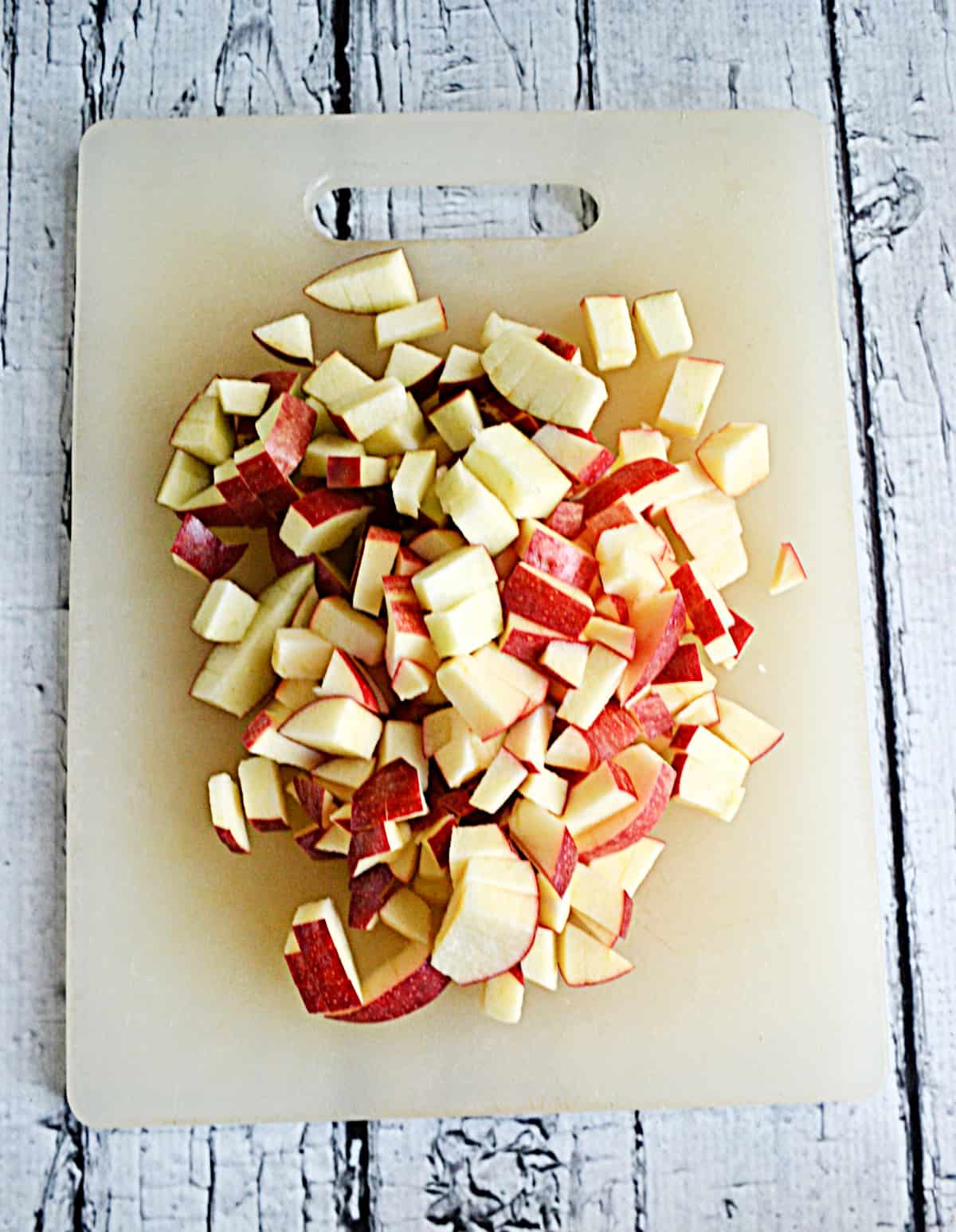 Diced apples on a cutting board.