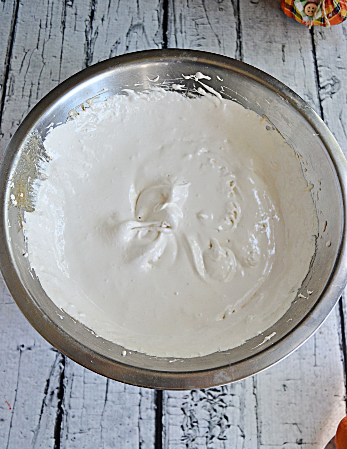 A bowl of whipped buttercream frosting. 