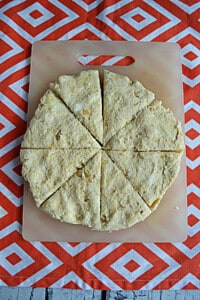 A round of scone dough cut into eight pieces.