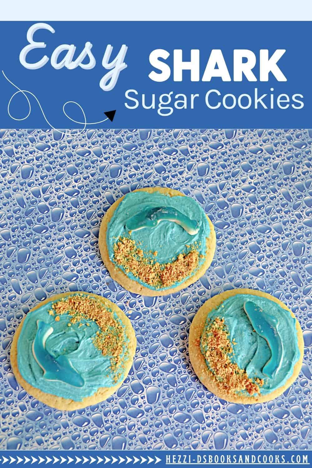 Pin Image: Text title, three sugar cookies with blue frosting, graham cracker crumb sand, and blue shark gummies.