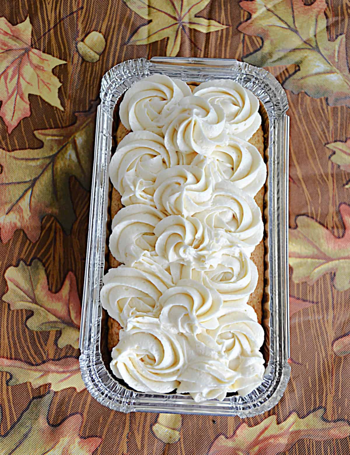 A pan of pumpkin cake with frosting on top.